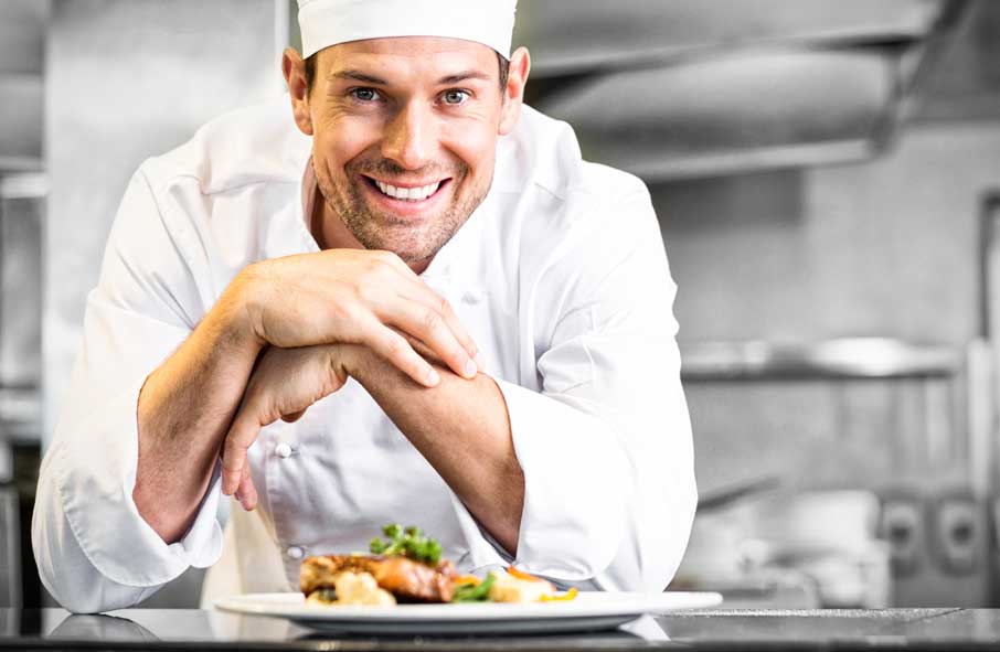 Smiling Chef with Prepared Food